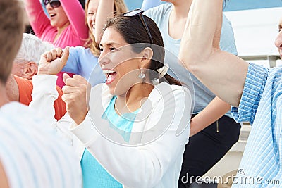 Woman In Crowd Celebrating At Sports Event Stock Photo