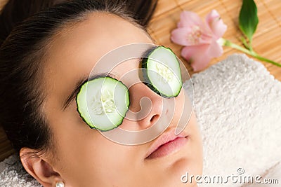 Woman with cucumber slices on eyes. Stock Photo