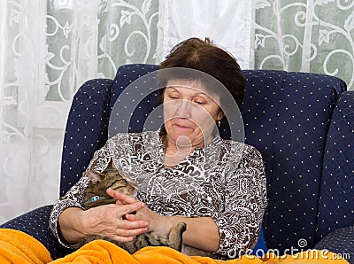Woman cuddles cat Stock Photo