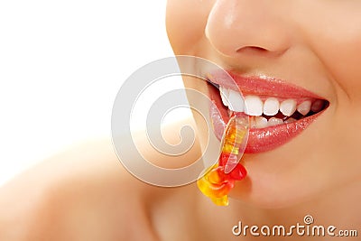 Woman with cute sweet candy closeup in teeth Stock Photo