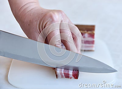 Woman cutting bacon Stock Photo