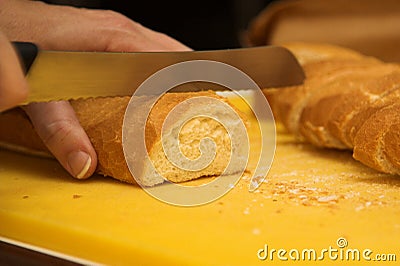 Woman cutting french loaf Stock Photo