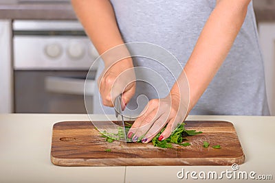 Woman cutting parsley with a knife Stock Photo