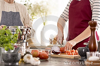 Woman cutting tomatoes Stock Photo