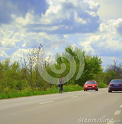 Woman cycling spring road scenery Stock Photo