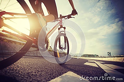 Woman cyclist legs riding Mountain Bike Stock Photo