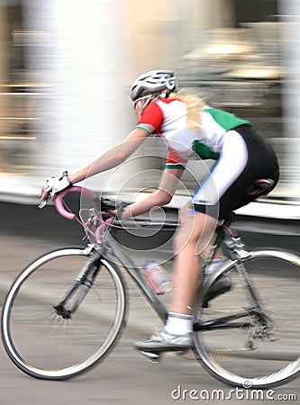 Woman Cyclist Racing Past Stock Photo