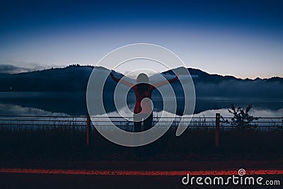 Woman at Czorsztyn Lake at dawn. Stock Photo