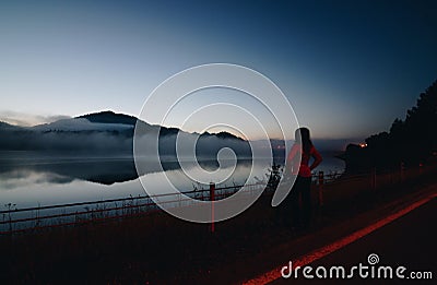 Woman at Czorsztyn Lake at dawn. Stock Photo