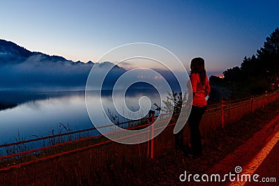 Woman at Czorsztyn Lake at dawn. Stock Photo