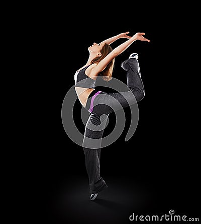 Woman dancer dancing modern dance, jump on a black Stock Photo