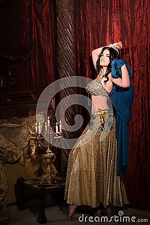 Woman dancing belly dance with shawl. Aesthetic of East Stock Photo