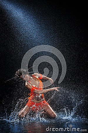 Woman dancing under rain Stock Photo