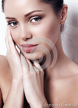 Woman with dark hair with natural makeup and radiance health skin posing Stock Photo