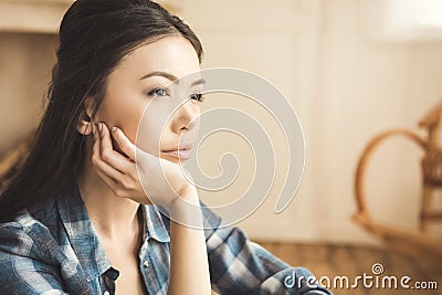 Woman daydreaming at home Stock Photo