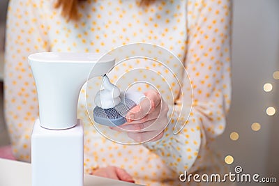 Woman deals the foam facial massager. Stock Photo