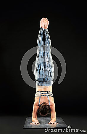 Woman demonstrating a forearm stand or pincha pose Stock Photo