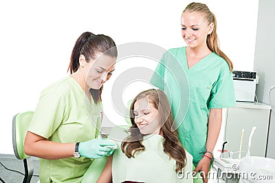 Woman dentist, assistant and patient Stock Photo