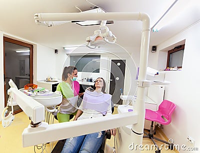 Woman dentist checking up her patient Stock Photo