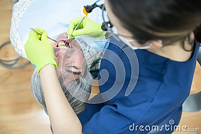 Woman dentist checks a patient`s mouth in a dental clinic. Dental health care and medicine concept Stock Photo