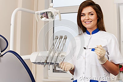 Woman dentist with dental tools Stock Photo