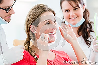Woman at dentist using dental floss Stock Photo