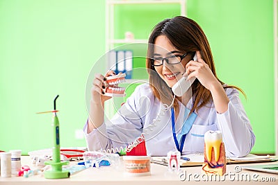 The woman dentist working on teeth implant Stock Photo