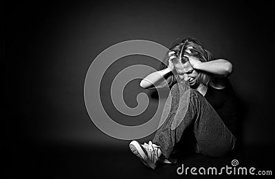 Woman in depression and despair crying, clutching his hands beh Stock Photo