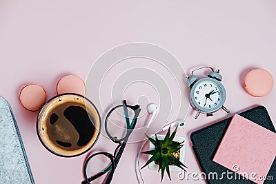 Woman Desk on pink glasses notepad kicking pencils plant macaroons alarm clock Top View Space For Text Stock Photo