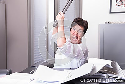 Woman is destroying her PC - overworked Stock Photo