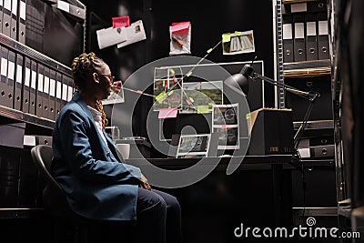 Woman detective assistant analyzing clues, working on crime solving Stock Photo