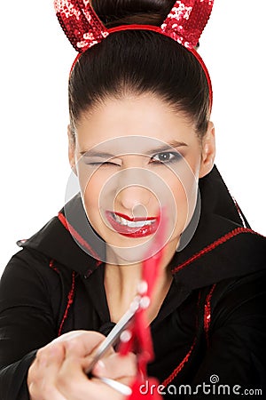 Woman in devil costume blinks eye. Stock Photo