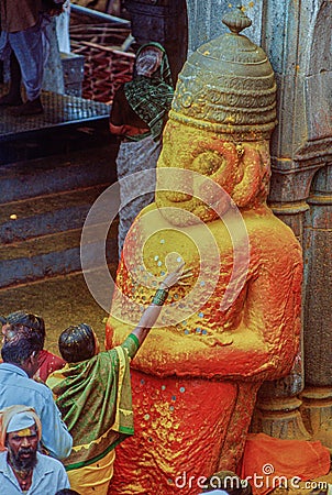 A woman devotee paying her respects to lord Khandoba at the Jejuri temple , Pune Editorial Stock Photo