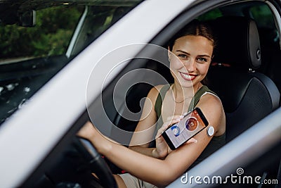 Woman with diabetes checking her blood glucose level before driving a car. Stock Photo