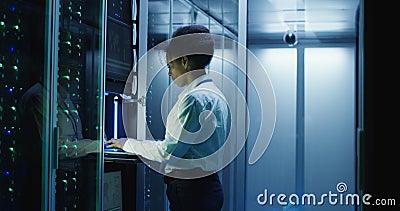 Woman diagnosing server hardware in center Stock Photo