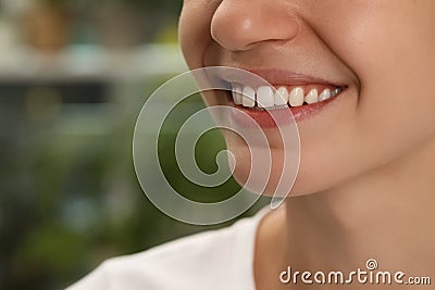 Woman with diastema between upper front teeth on blurred background, closeup Stock Photo