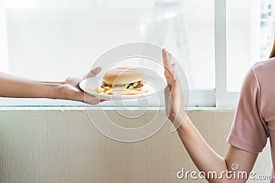 Woman on dieting for good health concept. Woman doing cross arms sign to refuse junk food or fast food hamburger and potato fried Stock Photo