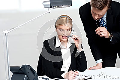 Woman discussing problem with male colleague Stock Photo