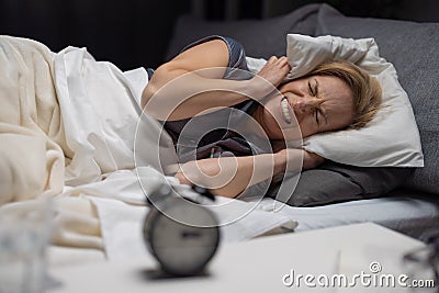 Woman disturbed by noisy neighbours Stock Photo