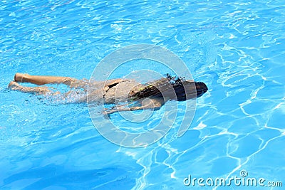 Woman diving underwater Stock Photo