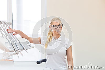 Woman doctor dentist posing near dental machine Stock Photo