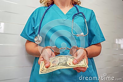 Woman doctor handcuffed. Bribe Stock Photo