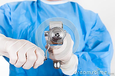 Woman doctor holding antique, old fashioned medical drill Stock Photo