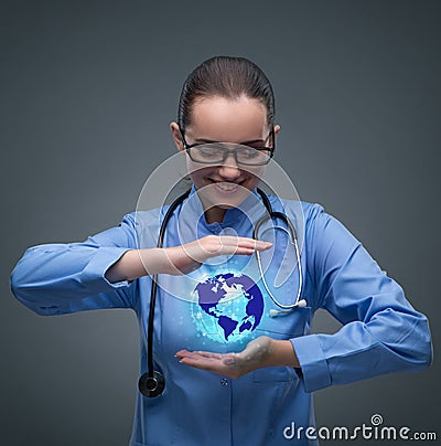 The woman doctor holding earth in globalisation concept Stock Photo