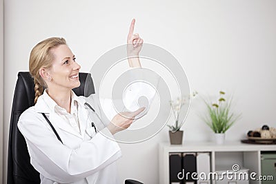 Woman Doctor Pointing and Looking to Upper Right Stock Photo