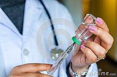 Woman doctor preparing for injection of vaccine or medicine Stock Photo