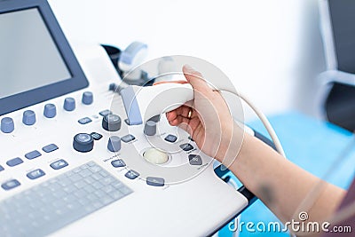 Woman doctor`s hands close up with ultrasound device scan Stock Photo