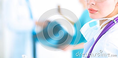 Woman doctor standing with stethoscope at hospital Stock Photo