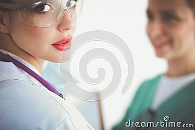 Woman doctor standing with stethoscope at hospital Stock Photo