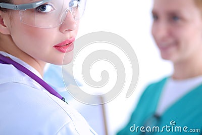 Woman doctor standing with stethoscope at hospital Stock Photo